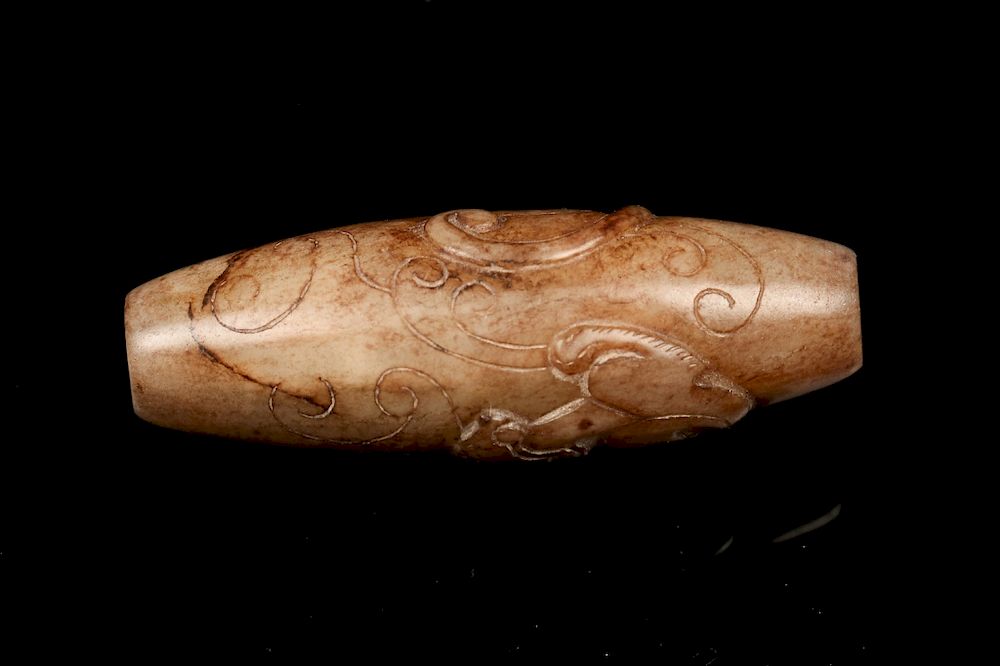 Appraisal: LARGE JADE MYTHICAL BEAST BEAD A carving of elongated ovoid