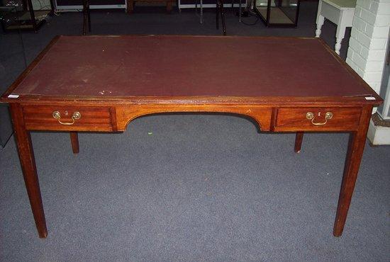 Appraisal: A mahogany desk fitted a drawer each side of the