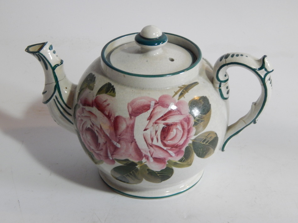 Appraisal: A thC Wemyss Pottery teapot the circular body with moulded