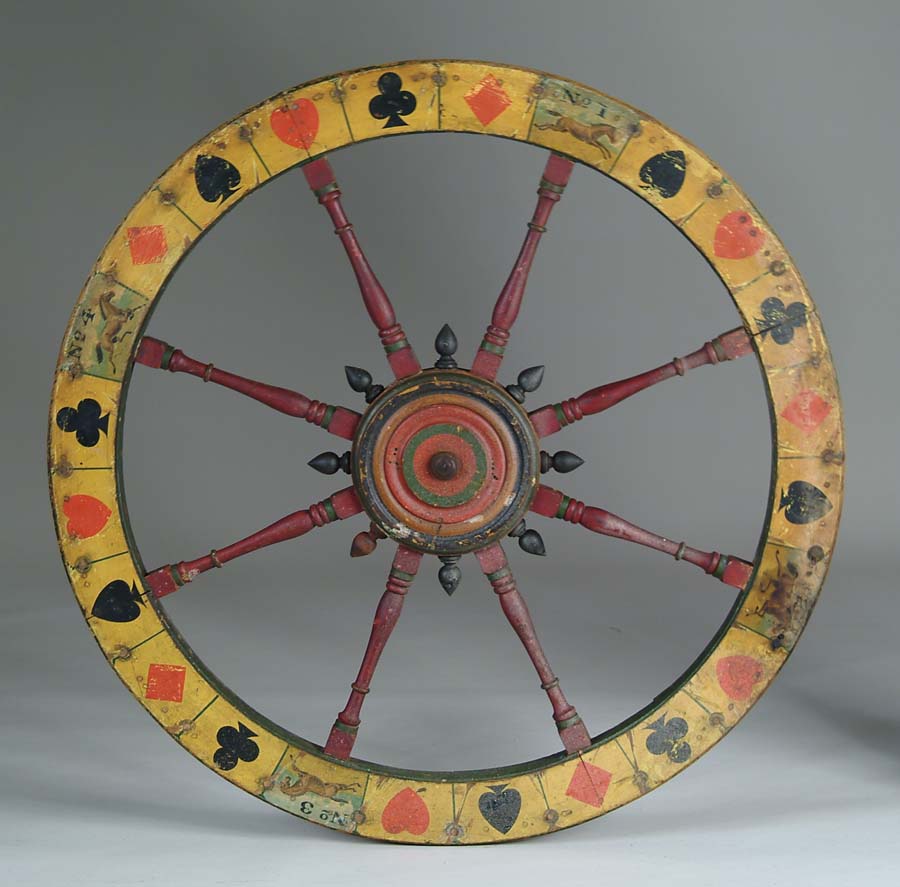 Appraisal: EARLY WOOD GAMING WHEEL Colorful roulette style wheel decorated with