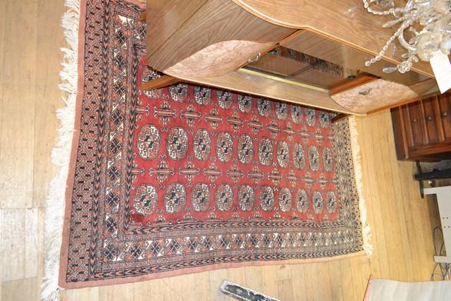 Appraisal: A PERSIAN RUG IN RED CREAM AND BLACK TONES A