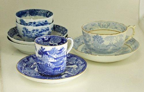 Appraisal: A blue and white willow pattern cup and saucer with