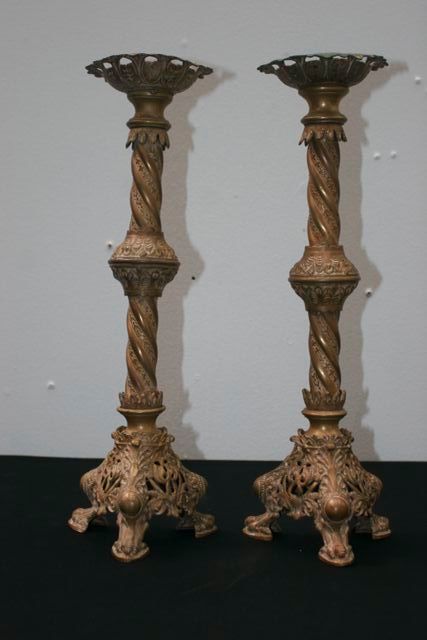 Appraisal: A pair of brass cathedral candelstands on lion feet each