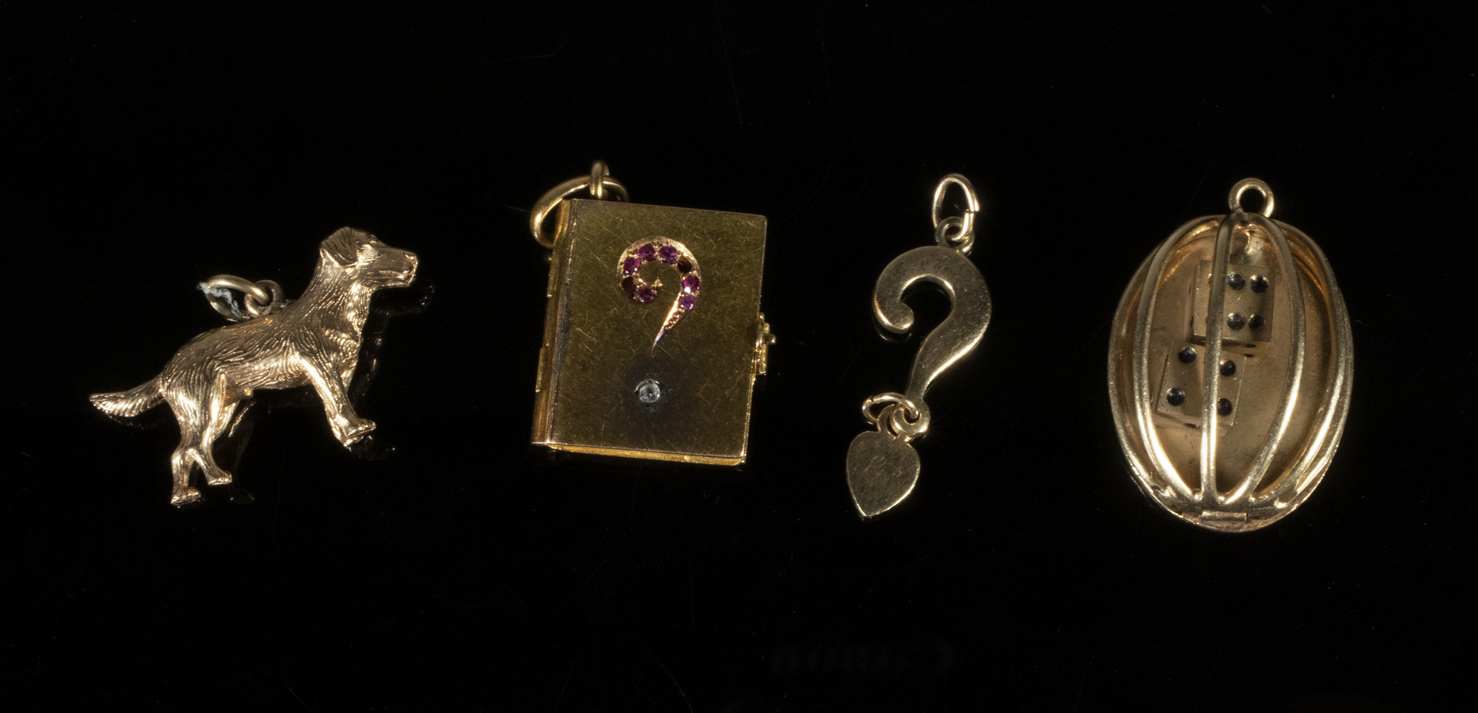 Appraisal: GOLD CHARMS Including Book form set with rubies and diamond