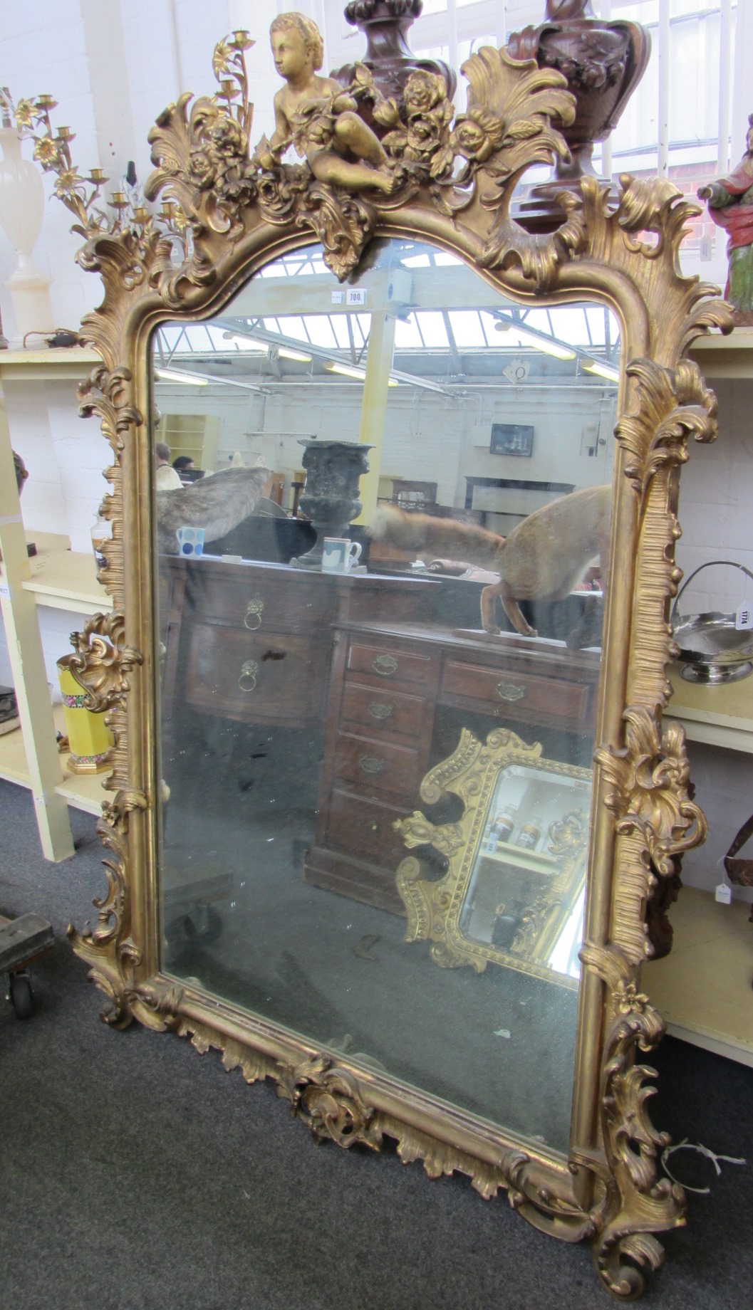 Appraisal: A th century French giltwood overmantel mirror the crest centred