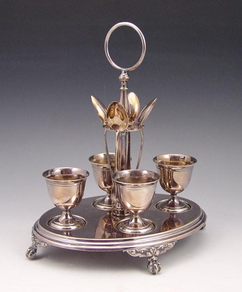 Appraisal: WMF SILVERPLATE EGG CUP STAND Paw feet stand cups and