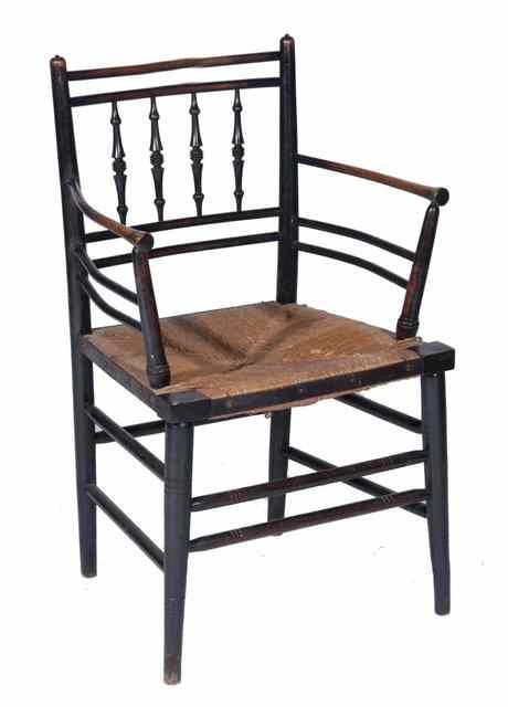 Appraisal: A MORRIS CO STYLE EBONISED SPINDLE BACK ELBOW CHAIR with