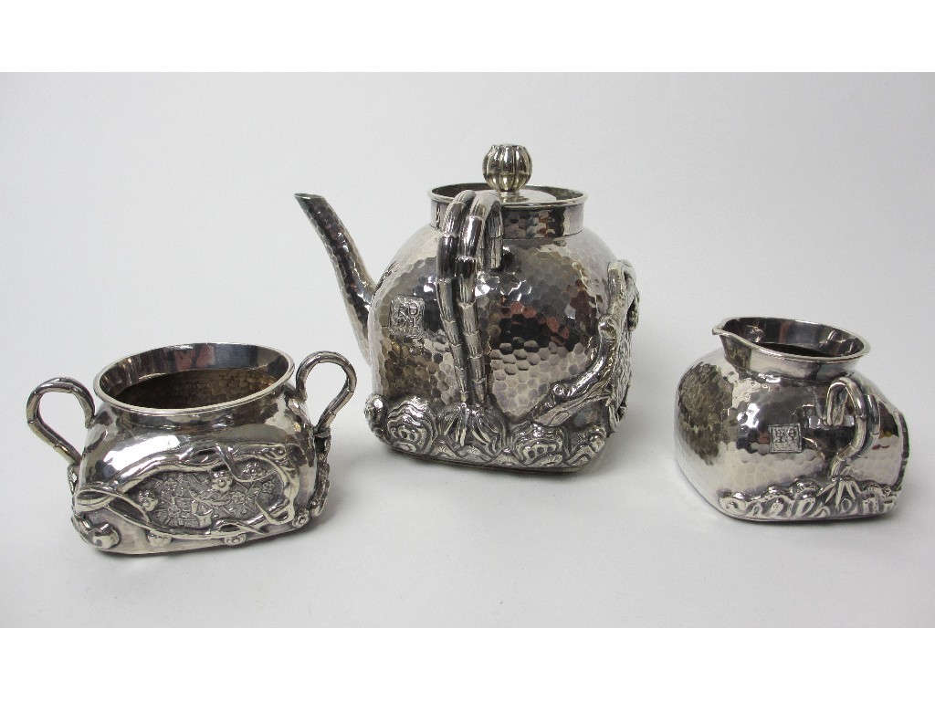 Appraisal: A three piece Chinese silver tea service the hammered body