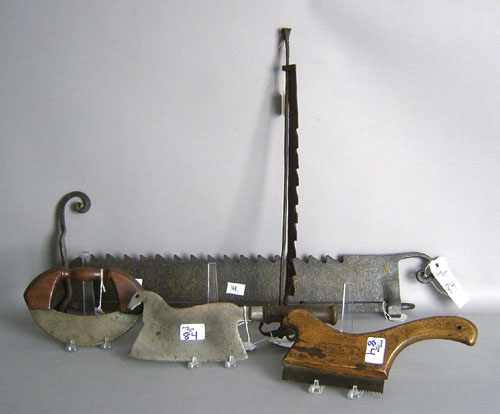 Appraisal: Two wrought iron trammels together with a saw dated horse