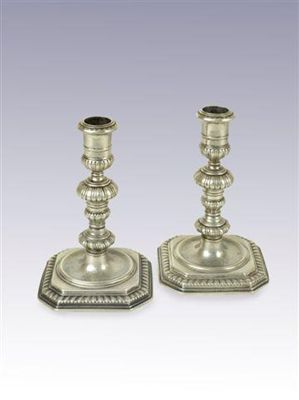 Appraisal: A pair of George I cast candlesticks on square bases