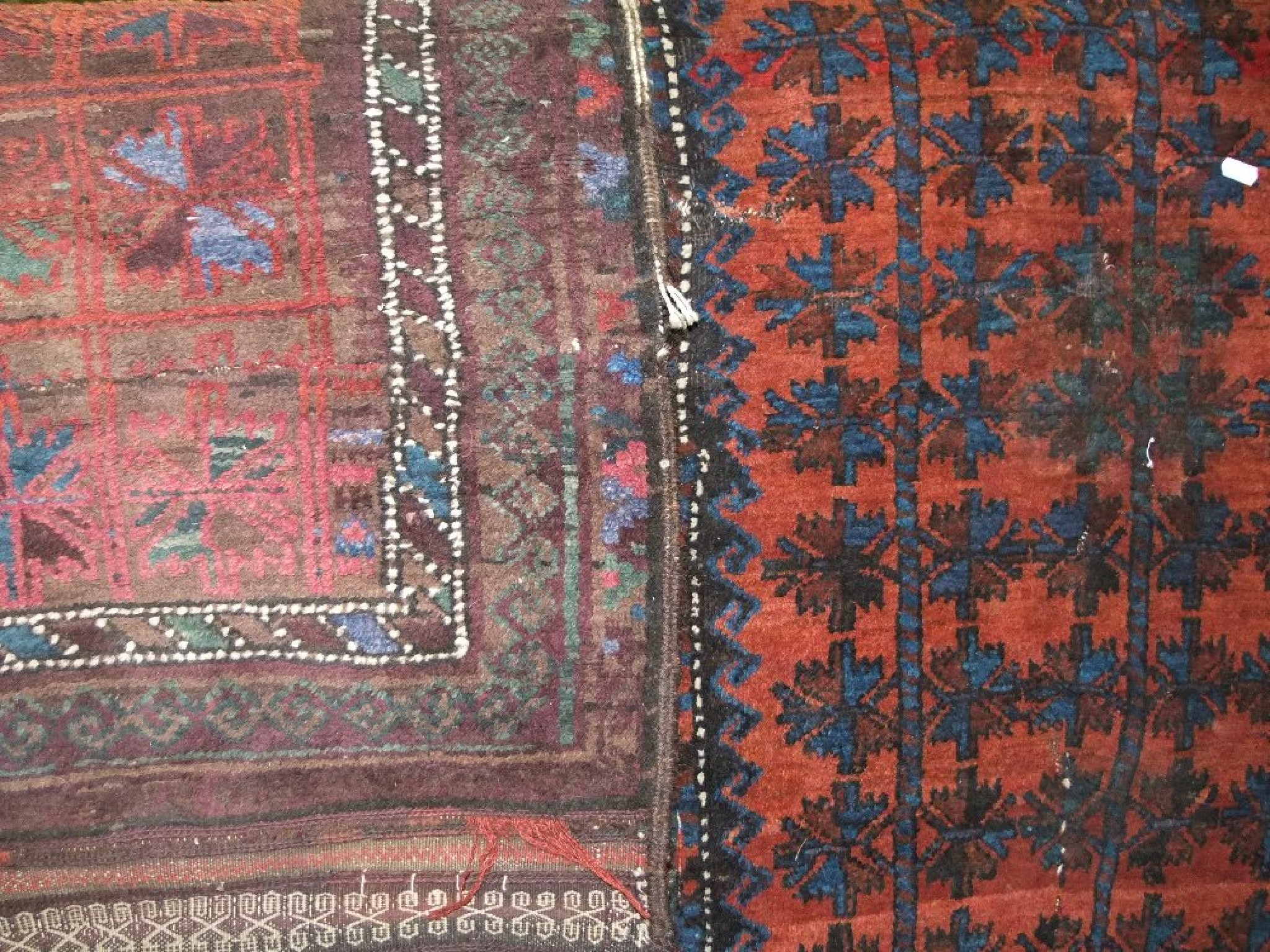 Appraisal: Two eastern wool rugs the larger example with plum ground