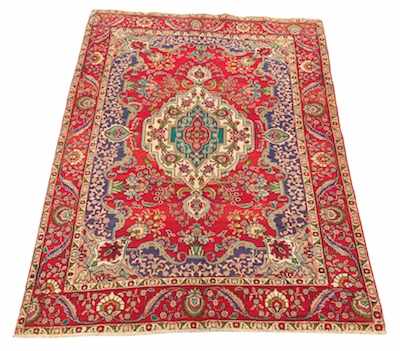 Appraisal: A Tabriz Carpet Bright red ground with flower motif on