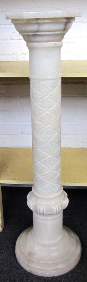 Appraisal: An alabaster jardiniere stand with diaper carved column fitted with