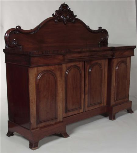 Appraisal: A Victorian mahogany inverted breakfront sideboard the arched foliate carved