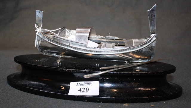 Appraisal: A CONTINENTAL SILVER MODEL of a rowing boat mounted on