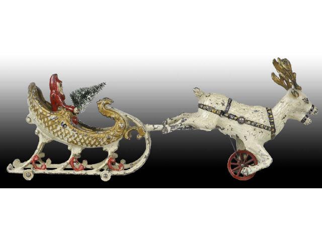 Appraisal: Cast Iron Hubley Santa Sleigh with White Reindeer Description Two