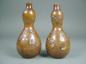 Appraisal: A pair of Japanese metal inlaid bronze gourd shaped vases