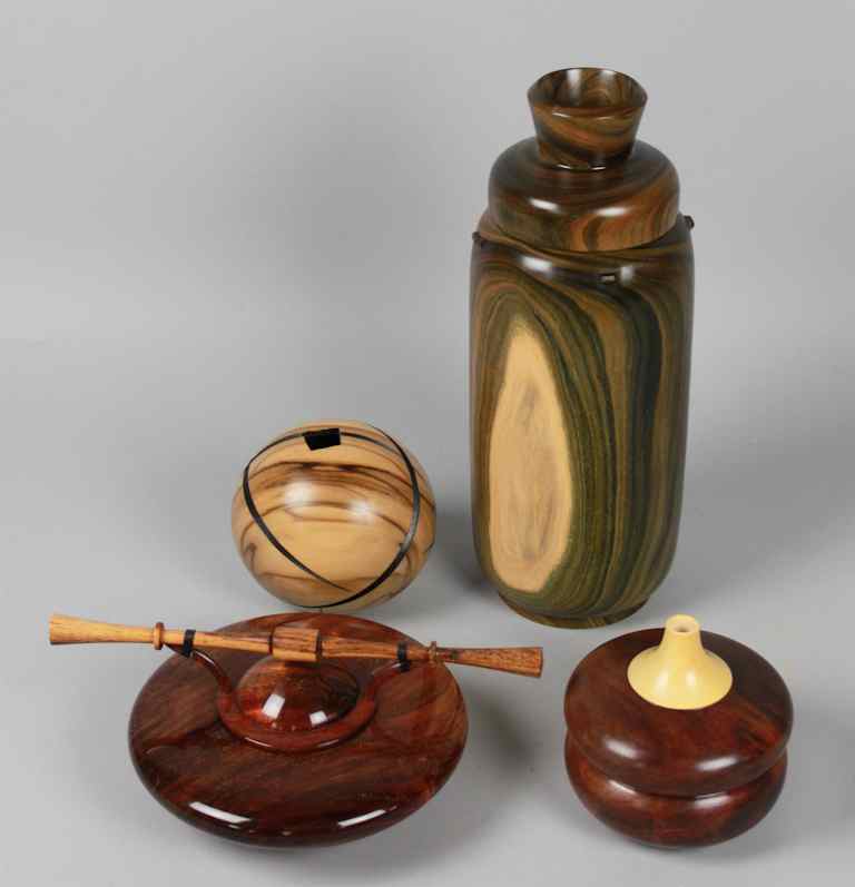 Appraisal: FOUR STRIATED HANDCRAFTED WOODEN VESSELS one two-toned vase an orb