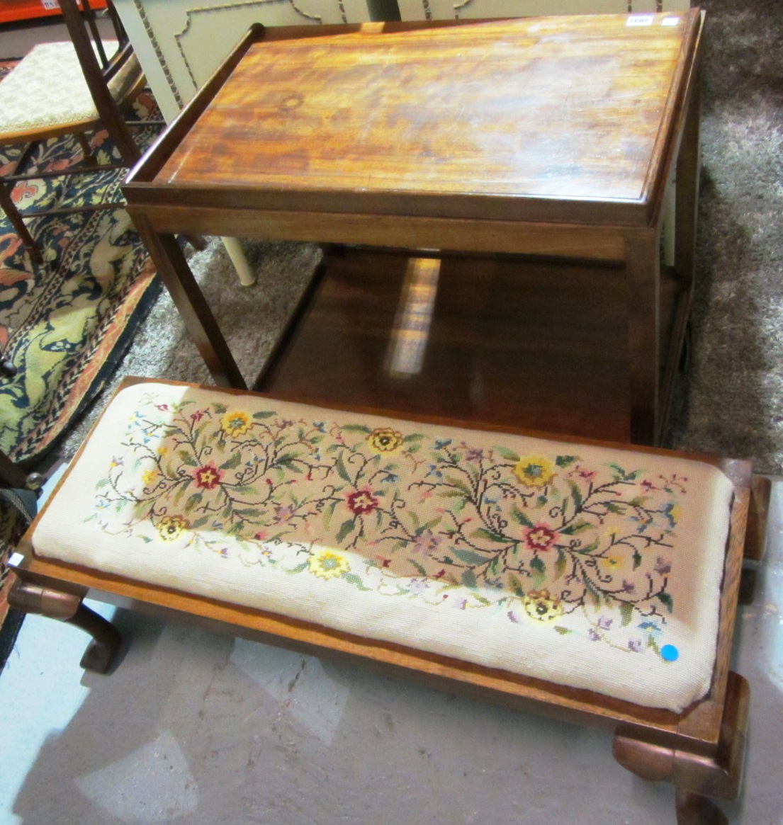 Appraisal: A mahogany two tier trolley and a rectangular footstool