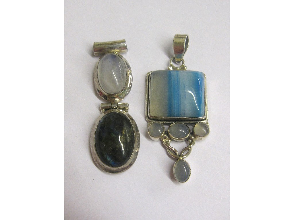 Appraisal: Two silver opalescent stone set pendants