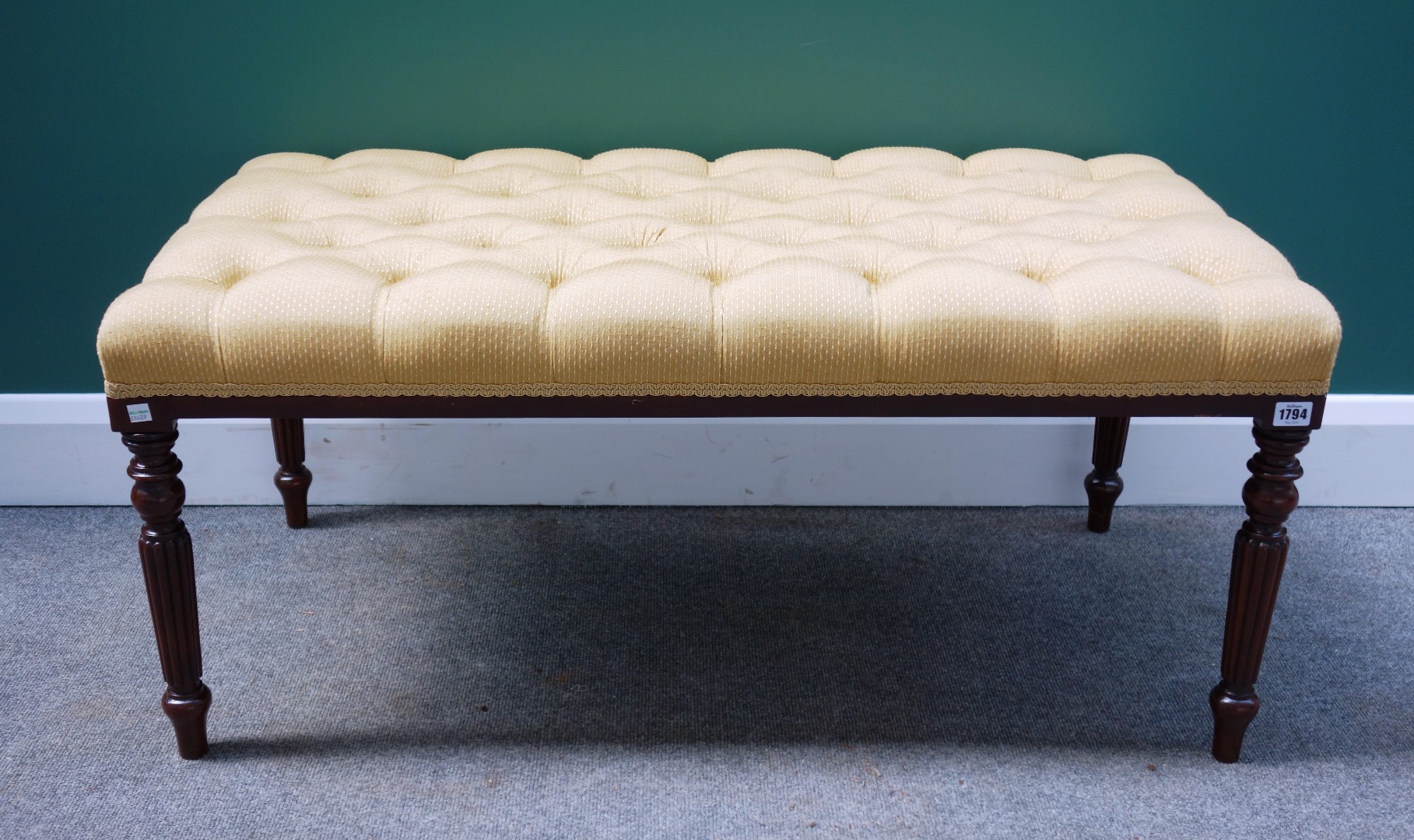 Appraisal: A rectangular footstool the buttoned over stuffed top on four