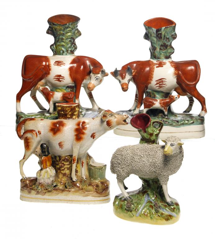 Appraisal: A PAIR OF STAFFORDSHIRE EARTHENWARE COW AND CALF SPILL HOLDER