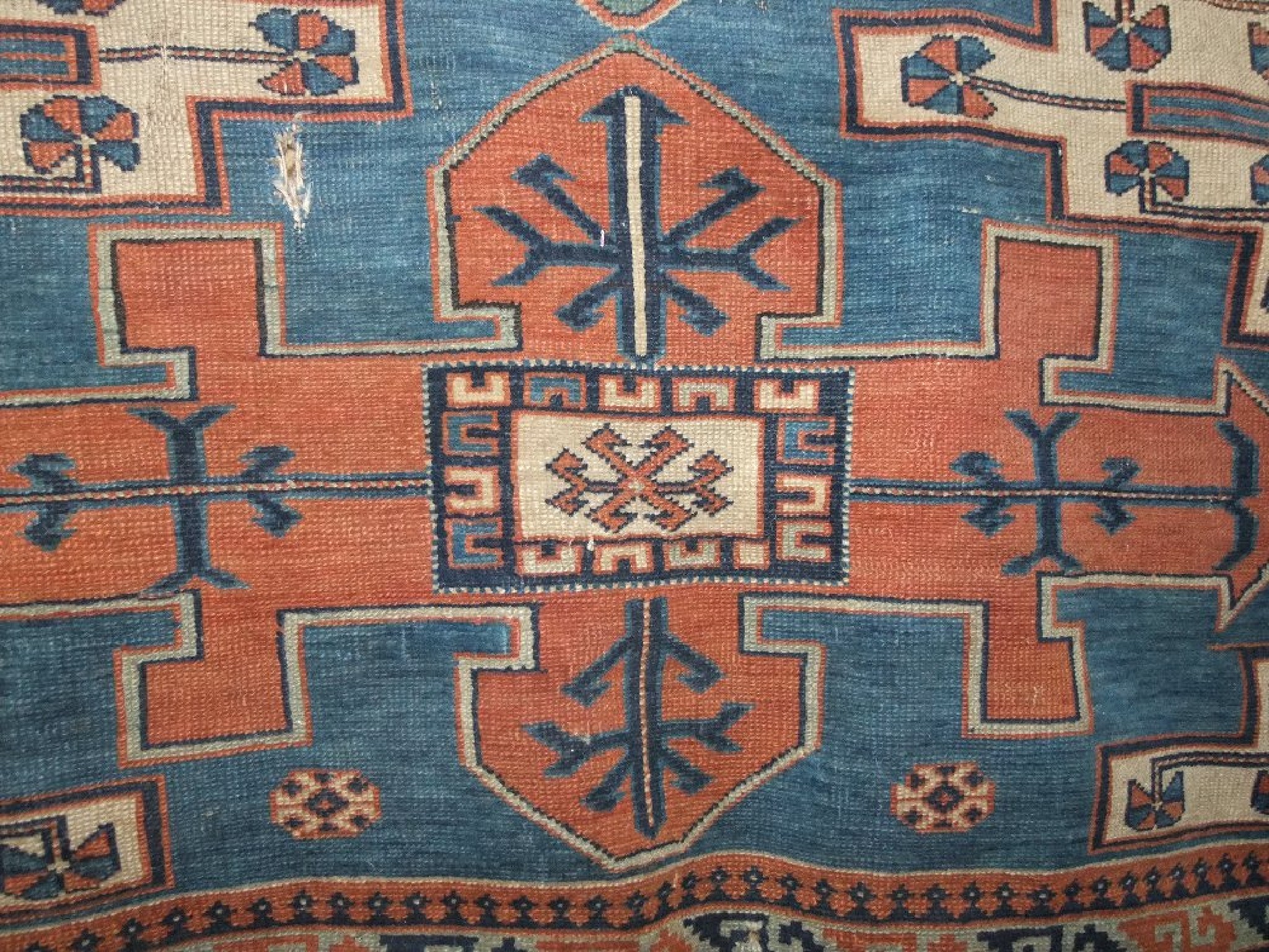 Appraisal: An eastern wool rug with blue ground field and geometric