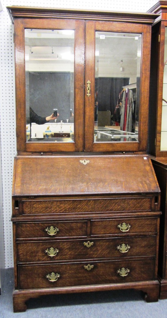 Appraisal: An early th century oak bureau cabinet with pair of