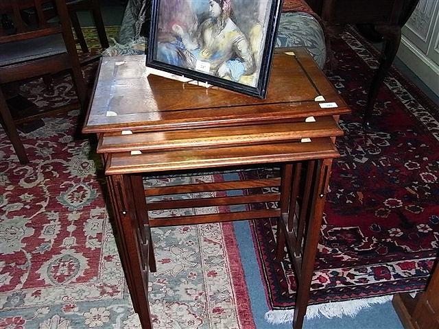 Appraisal: A nest of three Arts and Crafts tables with inlaid