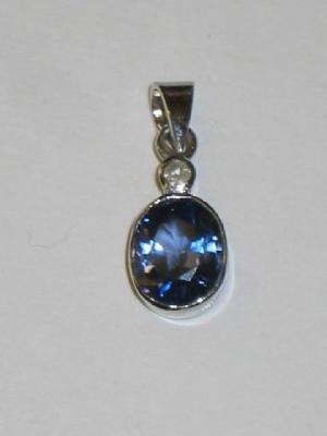 Appraisal: A SAPPHIRE AND DIAMOND PENDANT the oval cut sapphire collet