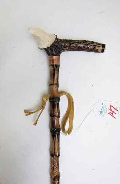 Appraisal: GENTLEMAN'S BAMBOO WALKING CANE chip-carved having an antler handle carved