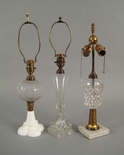 Appraisal: Three pressed clear glass fluid lamps th c now fitted