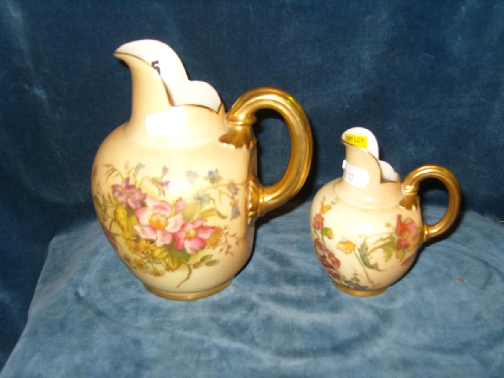 Appraisal: Two graduated Royal Worcester blush ivory flat back jugs with