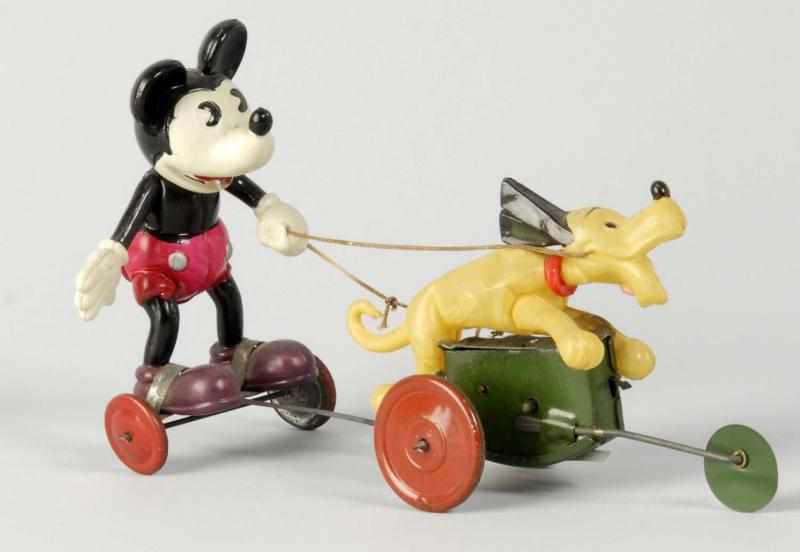 Appraisal: Celluloid Mickey in Cart Pulled by Pluto Toy Description Japan