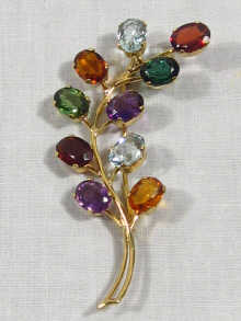 Appraisal: An carat gold spray brooch set with multicoloured gem stones