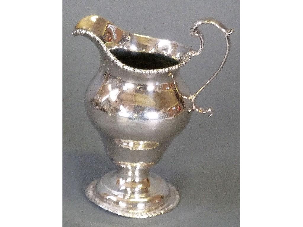 Appraisal: GEORGIAN SILVER PEDESTAL CREAM JUG oviform with high scroll handle