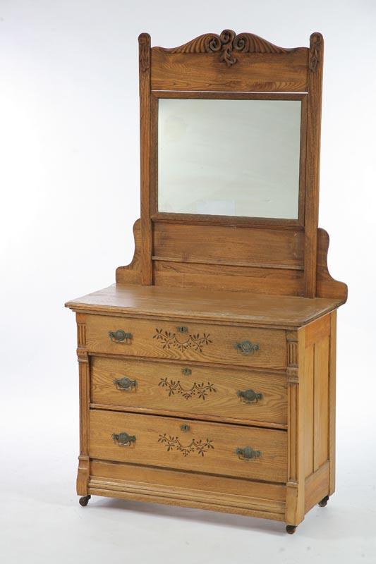 Appraisal: THREE DRAWER DRESSER WITH MIRROR Oak with a carved crest