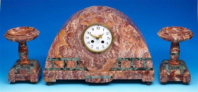 Appraisal: A French Art Deco salmon pink marble clock garniture de