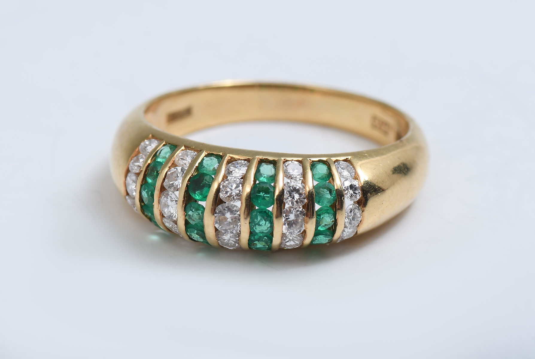 Appraisal: ITALIAN K DOMED EMERALD DIAMOND RING columns of emeralds alternate