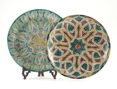 Appraisal: Two large pottery dishes probably North African decorated with stylized