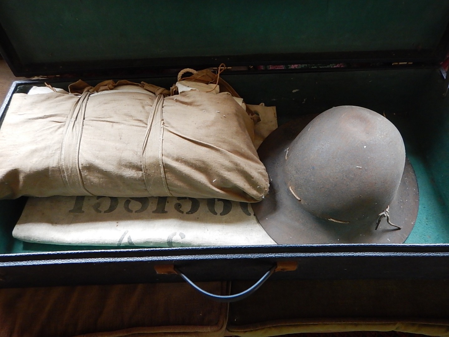 Appraisal: A vintage car trunk a military helmet and a canvas