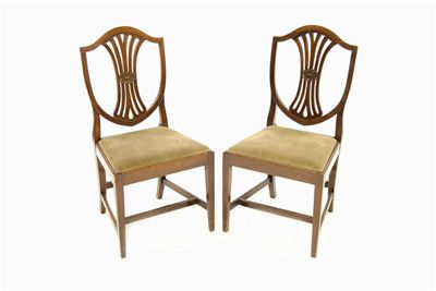 Appraisal: A set of four mahogany shield back chairs with drop