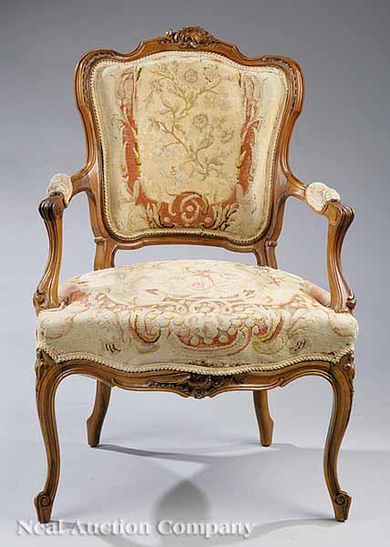 Appraisal: An Antique Louis XV-Style Carved Fruitwood Fauteuil shield-form back paddled