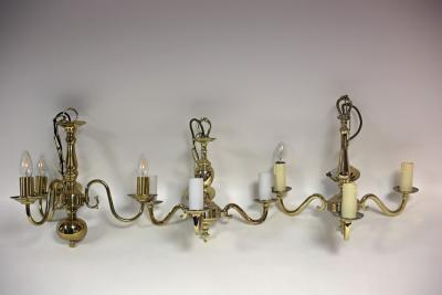 Appraisal: A Dutch brass three-light chandelier with scroll branches a three-light