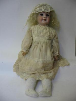 Appraisal: A late th century German bisque head girl doll with