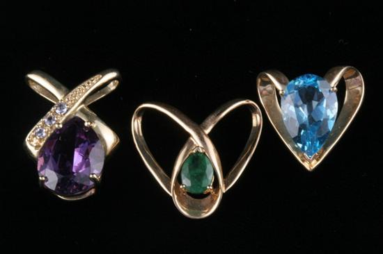 Appraisal: THREE YELLOW GOLD AND COLORED GEMSTONE PENDANTS Including one each