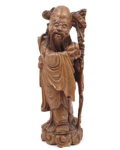 Appraisal: A Chinese wood carving of Shoulao with peach and gnarled