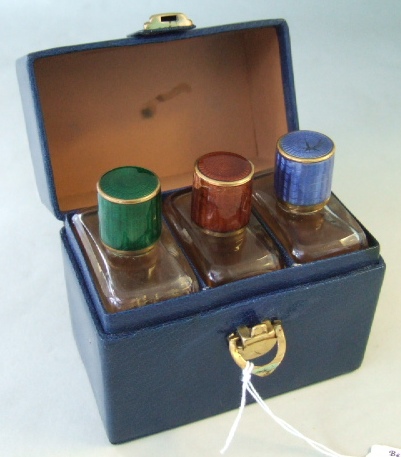 Appraisal: A set of three glass scent bottles with green brown