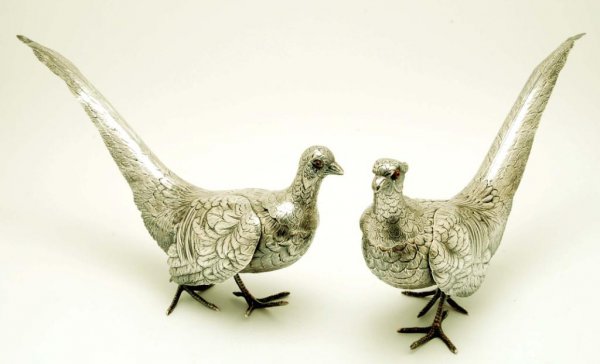 Appraisal: Pair of silver ringneck pheasant statues used as table decorations