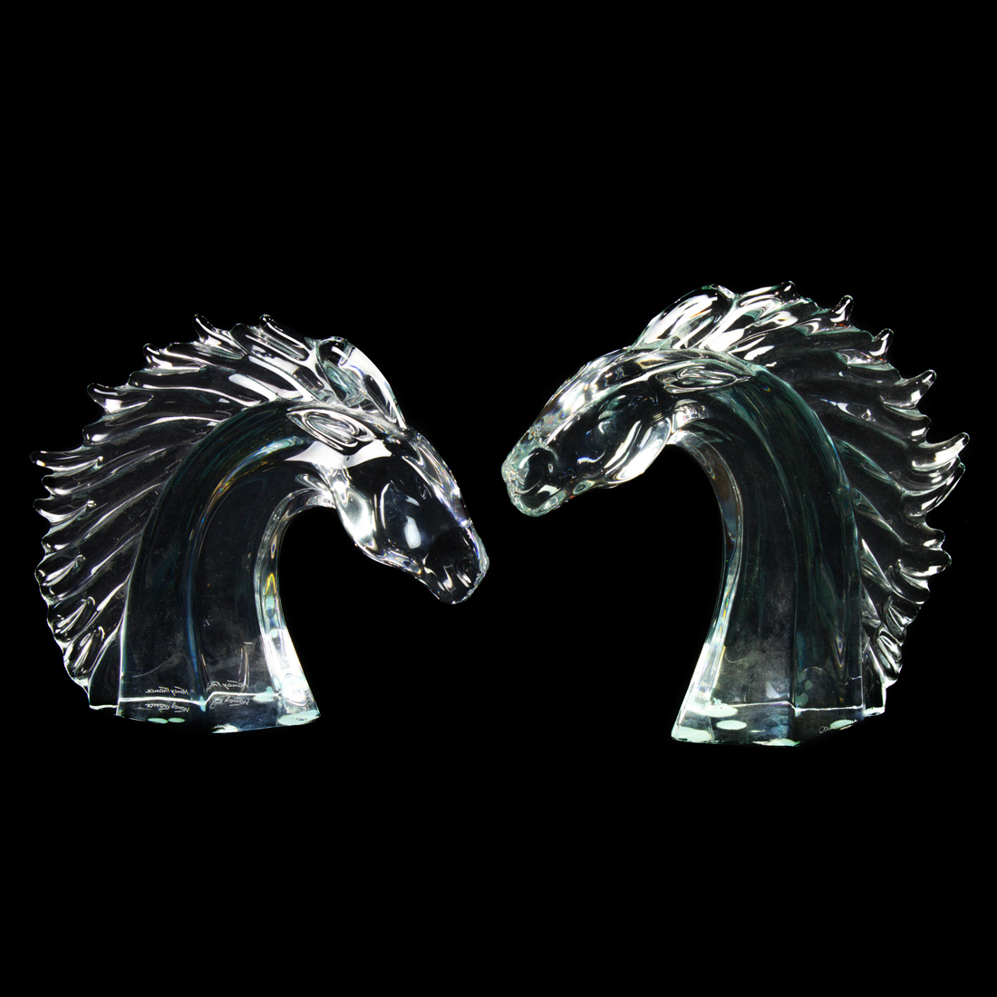 Appraisal: PAIR OF DAUM CLEAR GLASS HORSE HEADS Pair of Daum